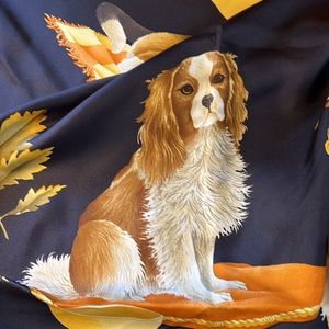 Adorable puppies on Salvatore Ferragamo silk scarf in blacks, browns, and gold